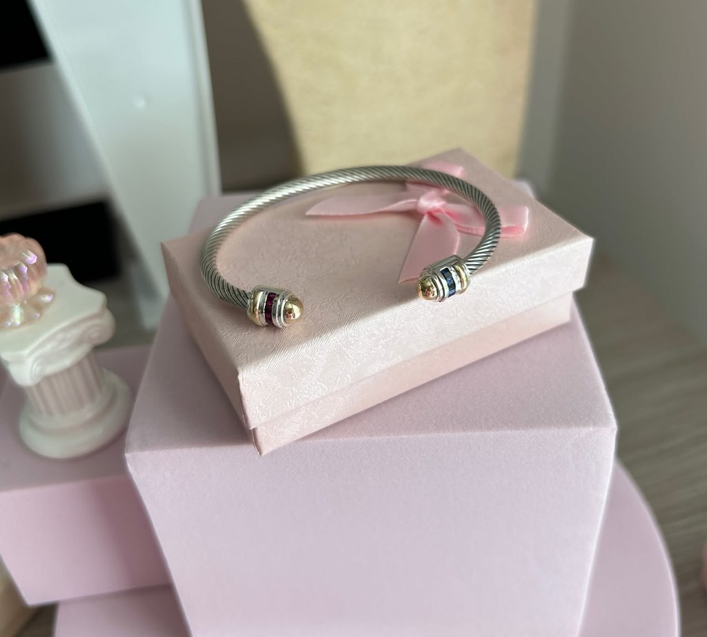 Silver ring with colored stone against dark background
